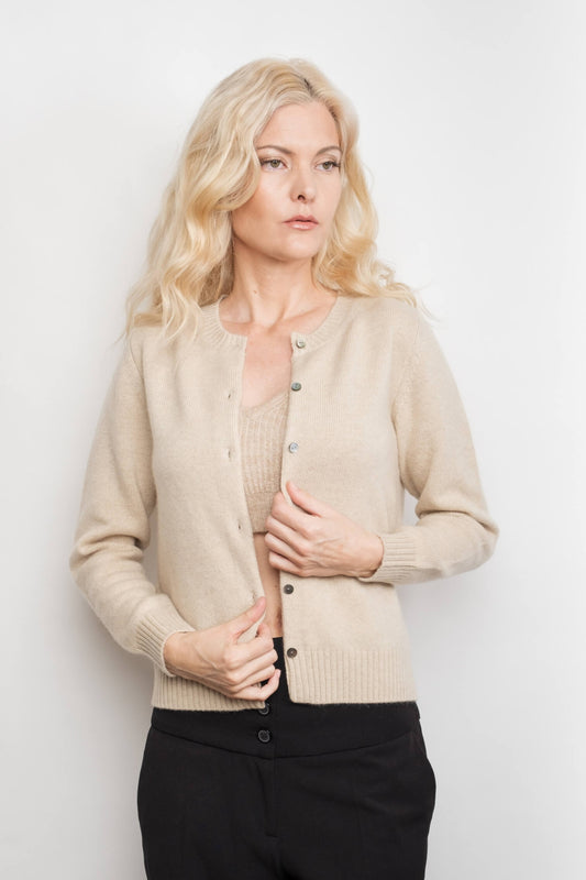Model holding placket of cream cashmere golfer cardigan – Love Cashmere NZ