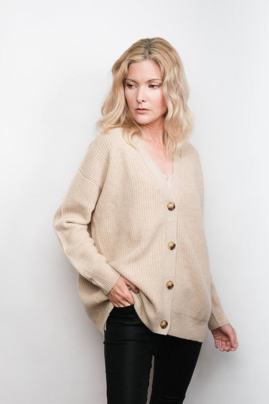 Model wearing buttoned beige cashmere cardigan, studio view – Love Cashmere NZ