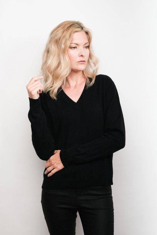 Model wearing black cashmere V-neck sweater, hand on hip – Love Cashmere NZ