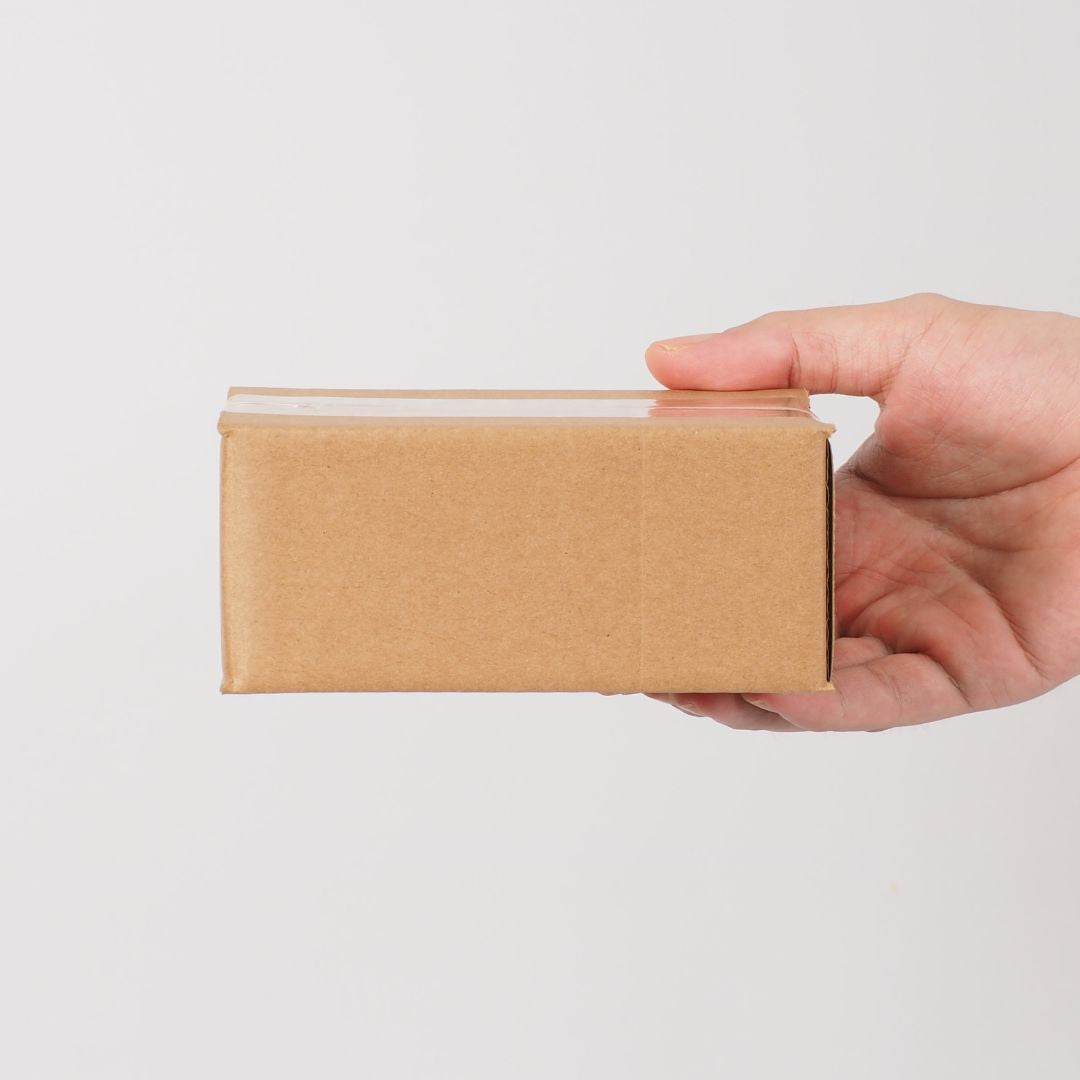 Hand holding small kraft courier box – LS Silk NZ