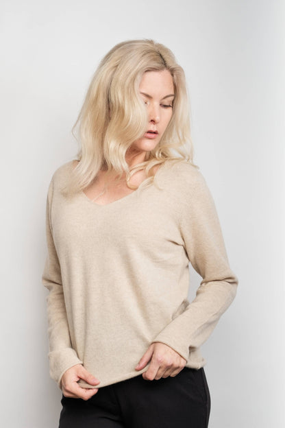 Model in loose-fit beige V-neck cashmere sweater, front view – Love Cashmere NZ