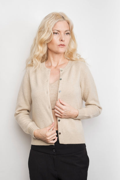 Model holding placket of cream cashmere golfer cardigan – Love Cashmere NZ