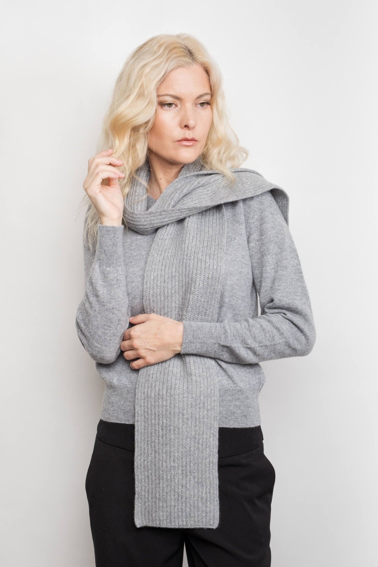 Model wearing slim ribbed grey cashmere scarf over grey sweater – Love Cashmere NZ