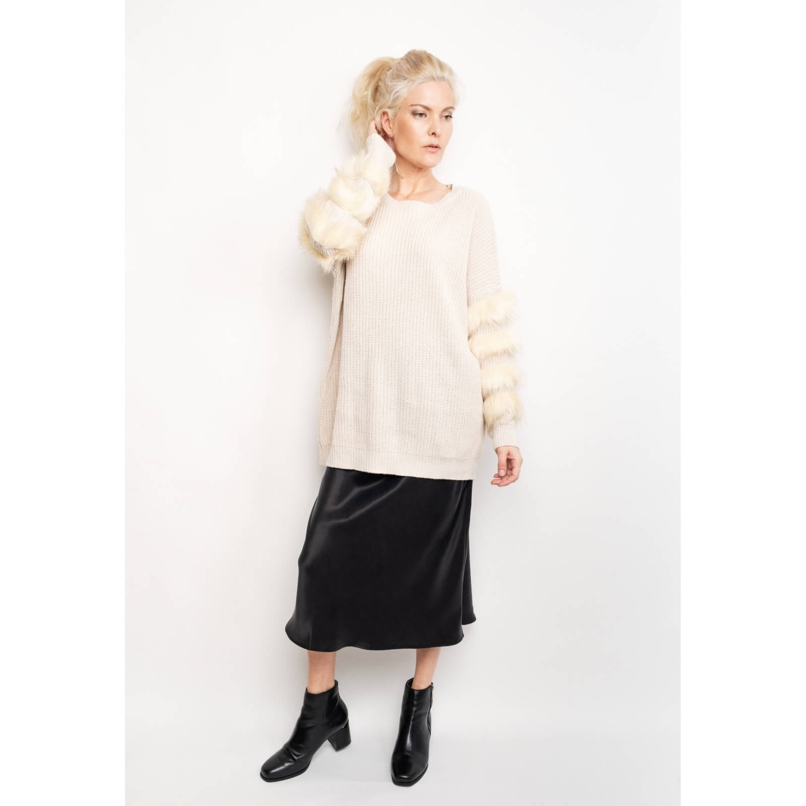 Woman styling black silk midi skirt with cream sweater and boots – LS Silk NZ