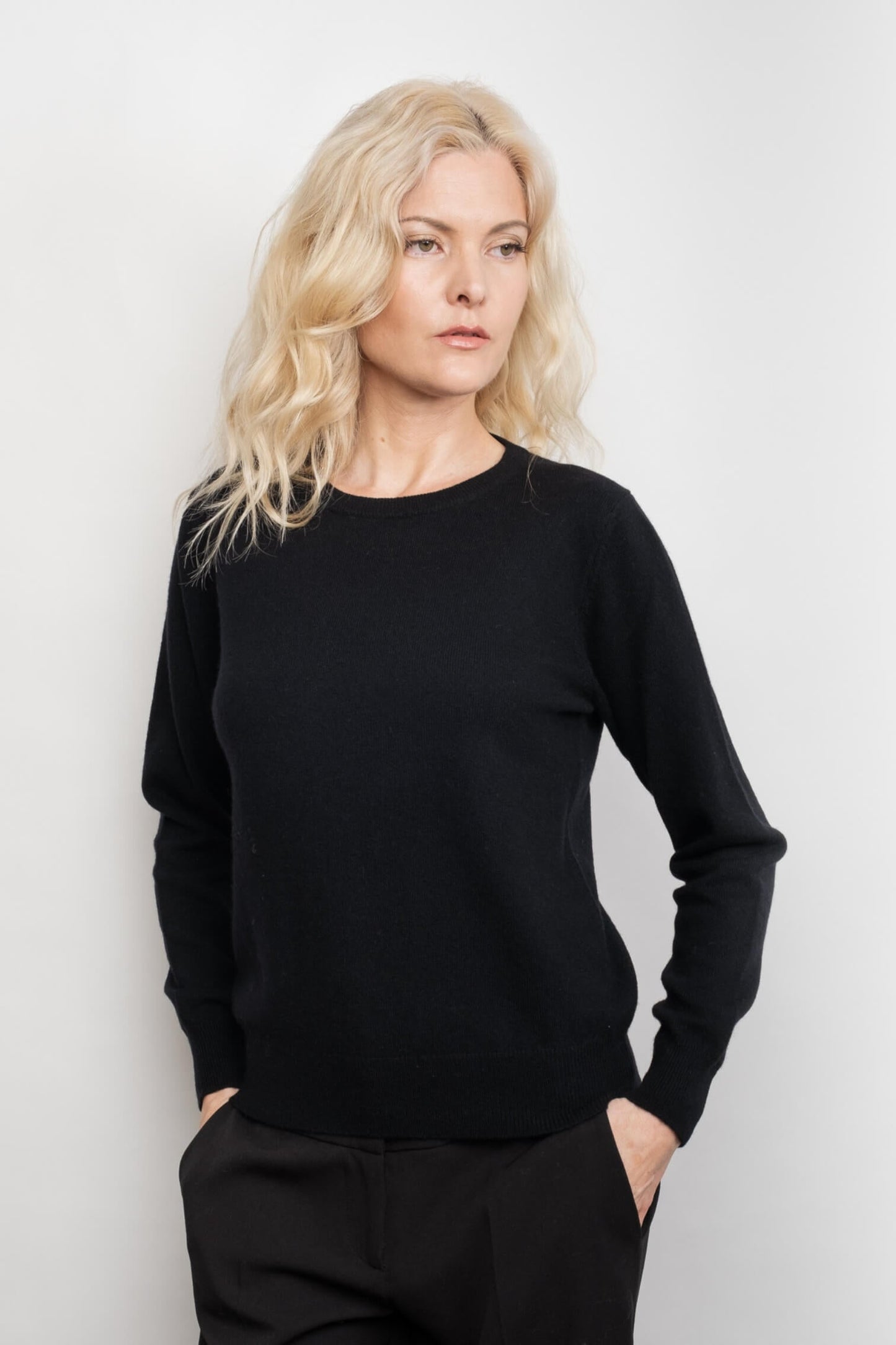 Model in black cashmere crewneck sweater, hand on hip – Love Cashmere NZ