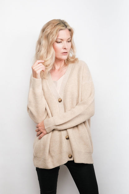 Model in beige cashmere cardigan with arms crossed – Love Cashmere NZ