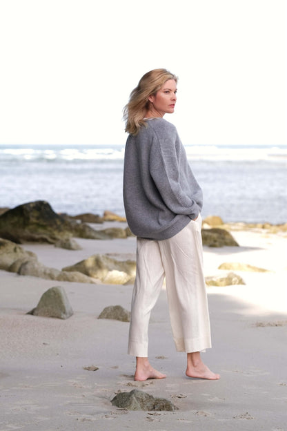 Woman in grey cashmere cardigan looking out to sea – Love Cashmere NZ