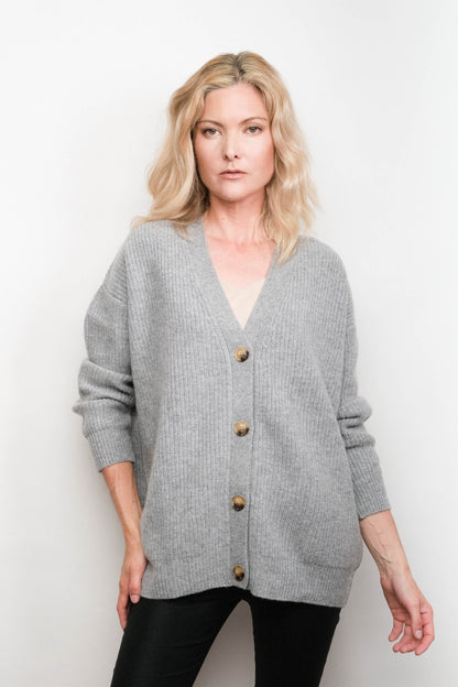 Model wearing grey relaxed V-neck cashmere cardigan, studio view – Love Cashmere NZ