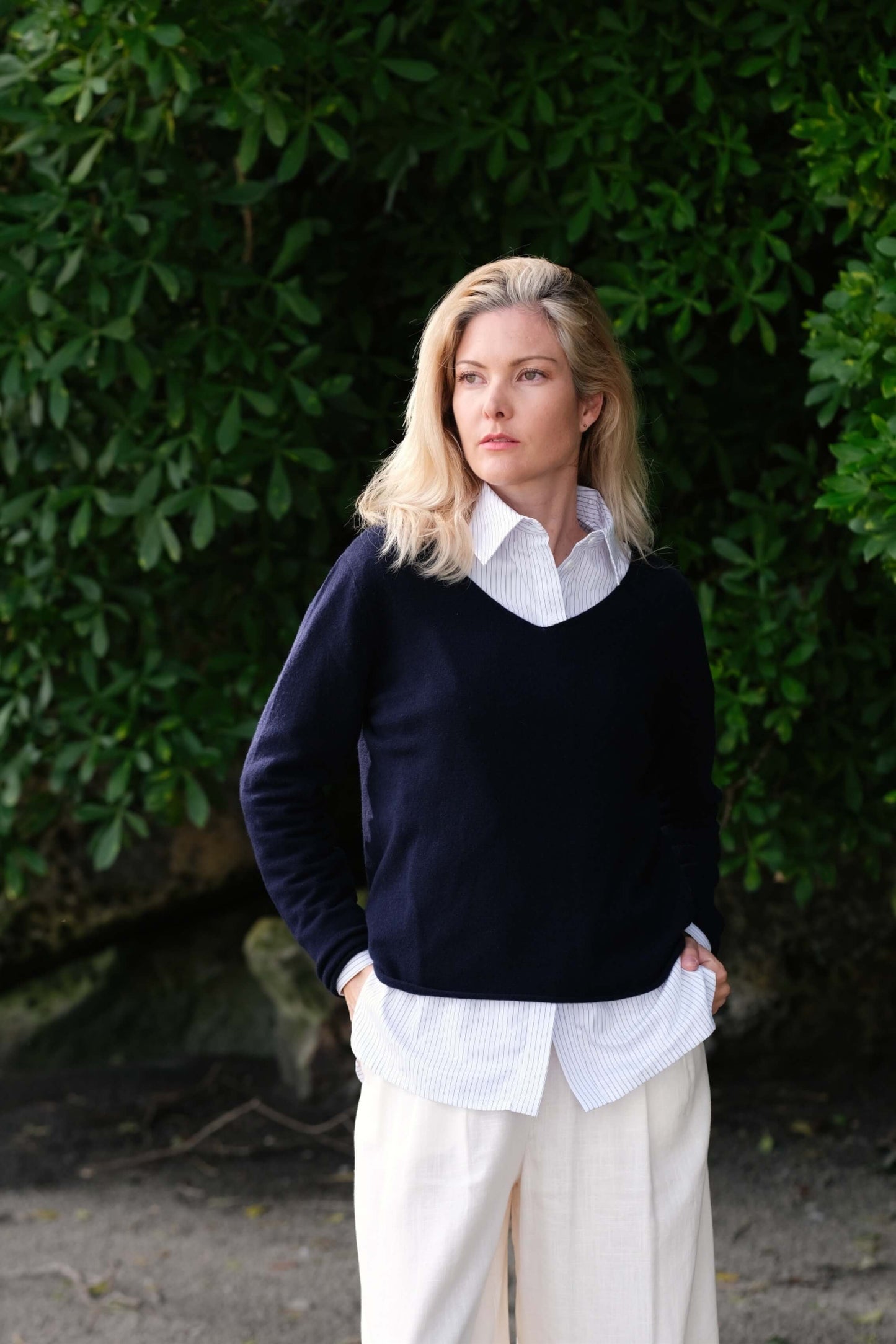 Full-length look: navy cashmere sweater with white pants outdoors – Love Cashmere NZ