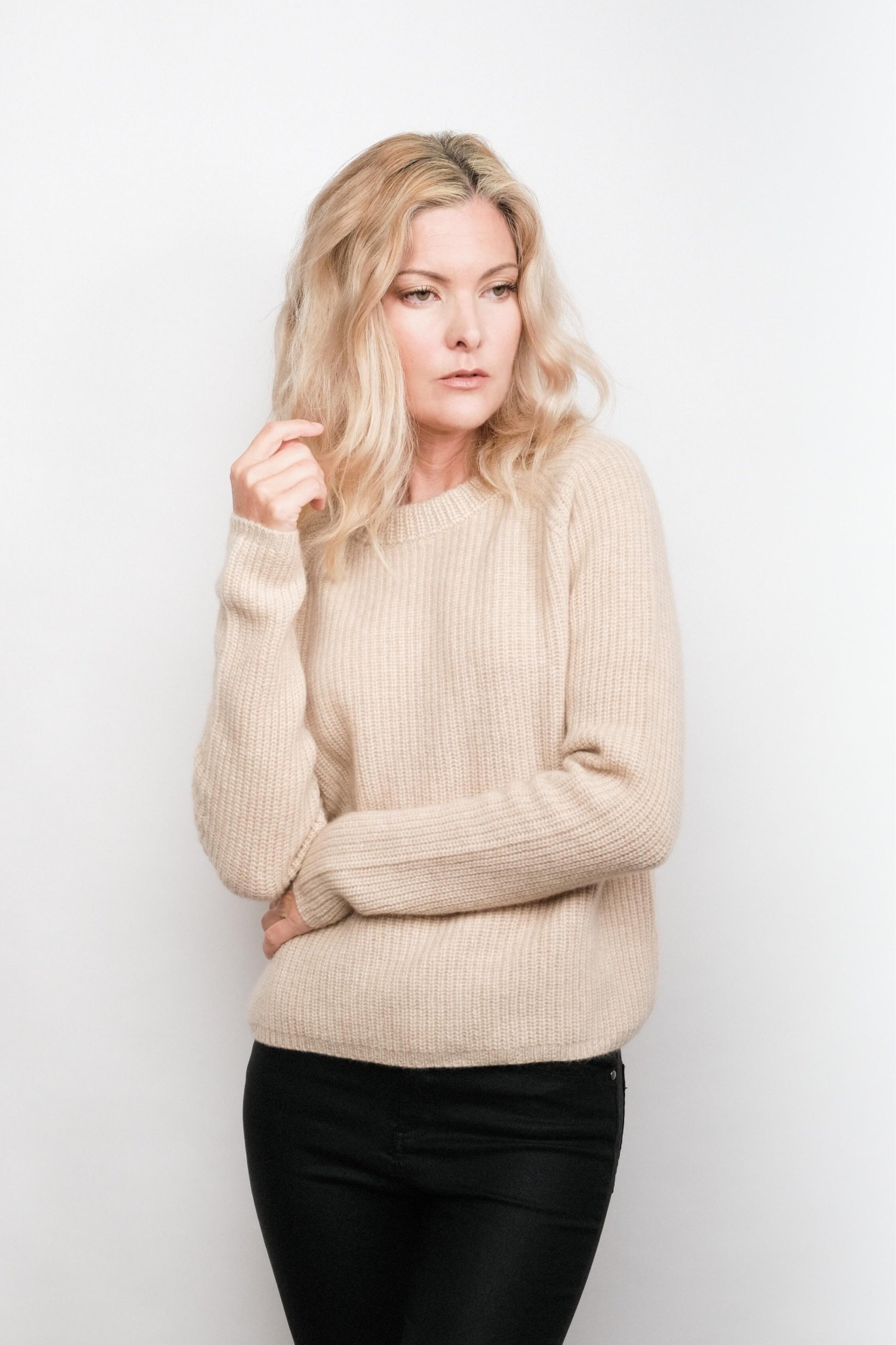 Model wearing beige fisherman cashmere sweater, studio view – Love Cashmere NZ