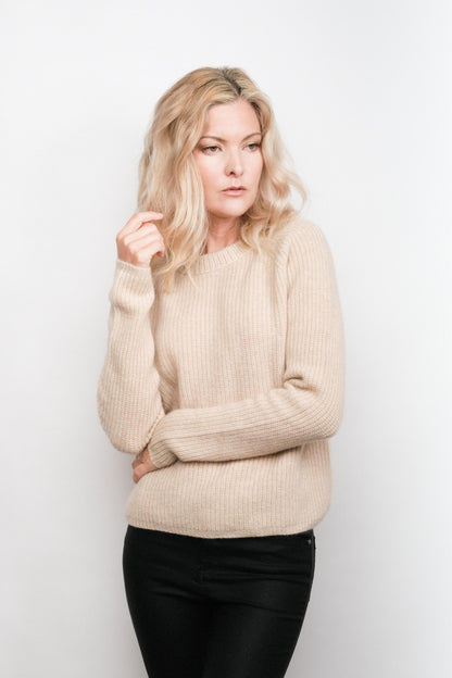 Model wearing beige fisherman cashmere sweater, studio view – Love Cashmere NZ