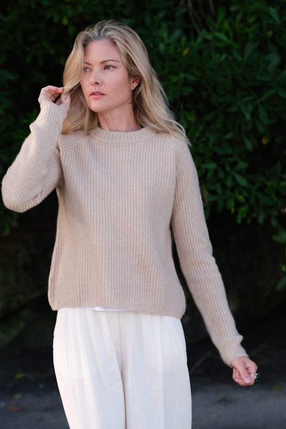 Woman outdoors in beige ribbed fisherman cashmere sweater – Love Cashmere NZ