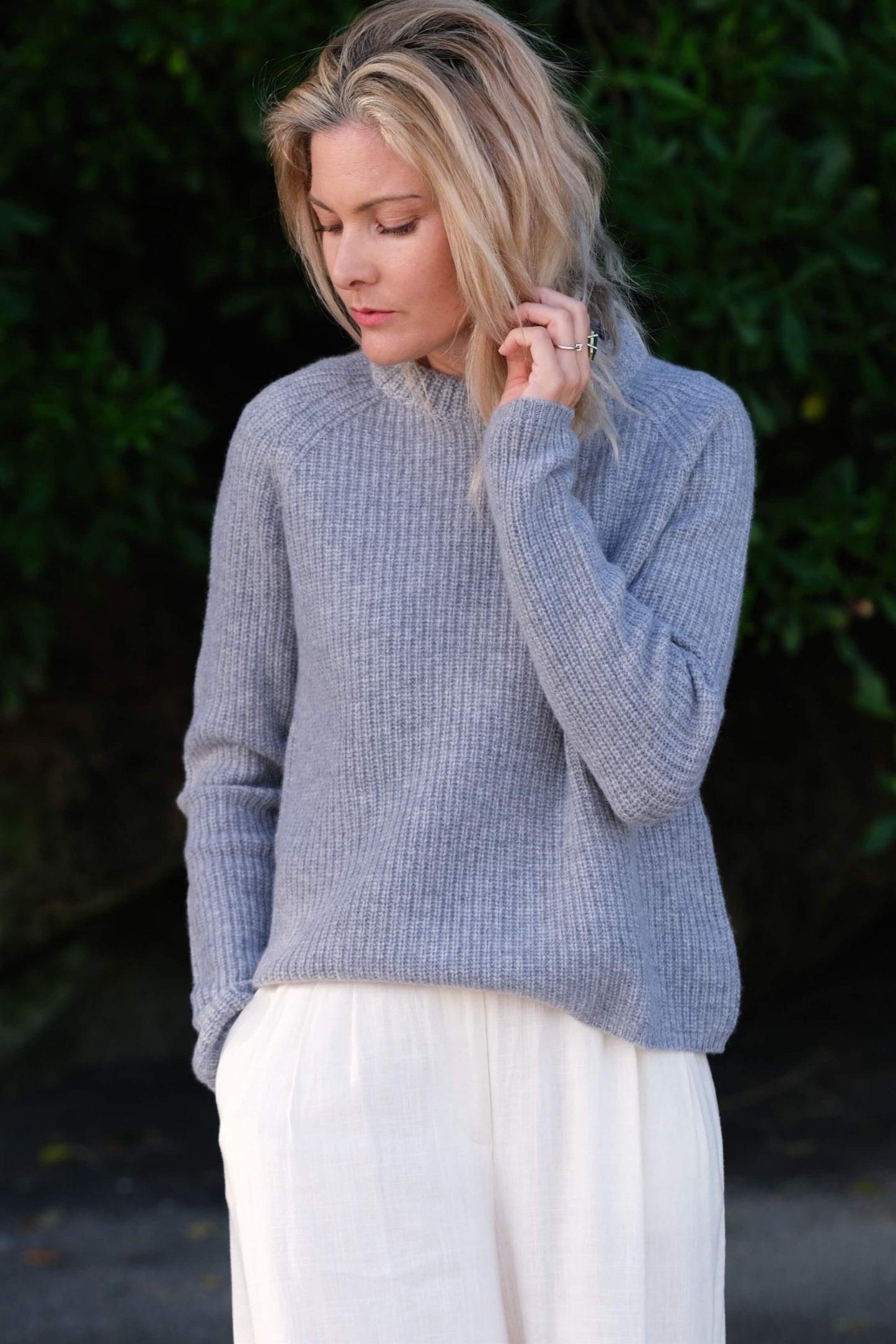 Woman outdoors in grey-blue fisherman cashmere sweater – Love Cashmere NZ