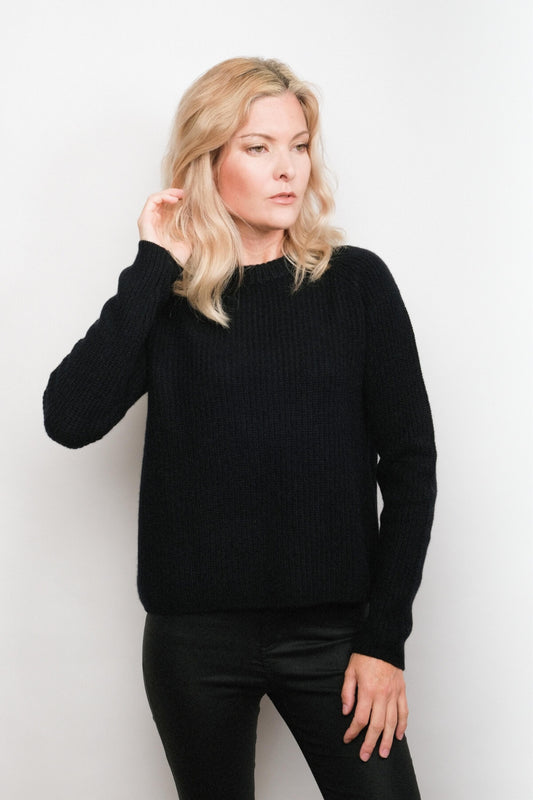 Model wearing black fisherman cashmere sweater, studio view – Love Cashmere NZ