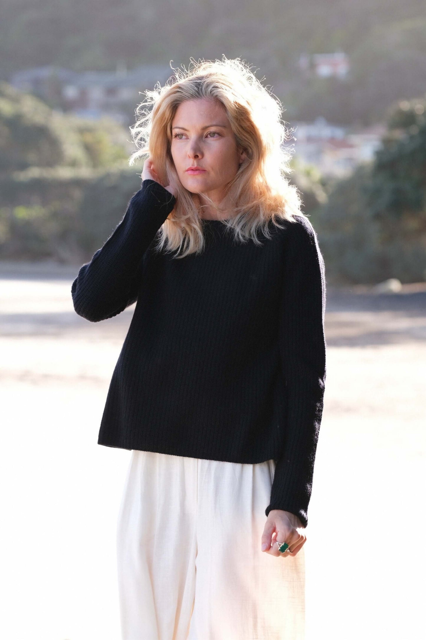 Woman in black cashmere fisherman sweater at the beach – Love Cashmere NZ