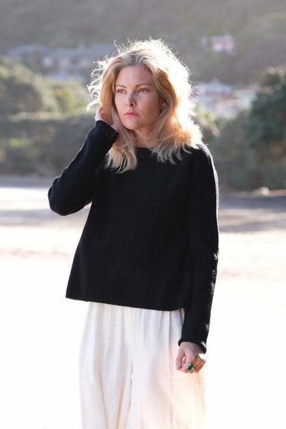 Woman in black cashmere fisherman sweater at the beach – Love Cashmere NZ