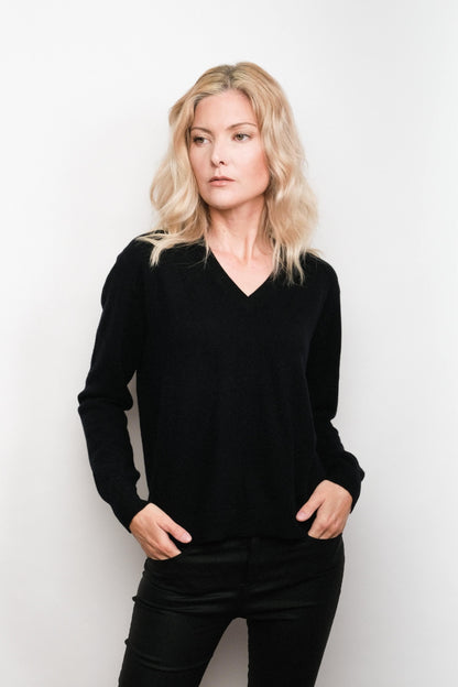 Model in black cashmere V-neck sweater, hands in pockets – Love Cashmere NZ
