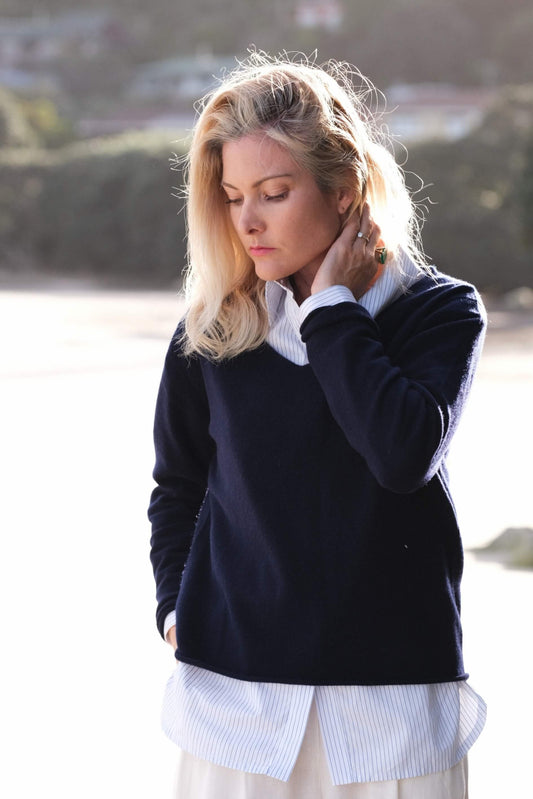 Woman outdoors in navy cashmere sweater over white shirt – Love Cashmere NZ