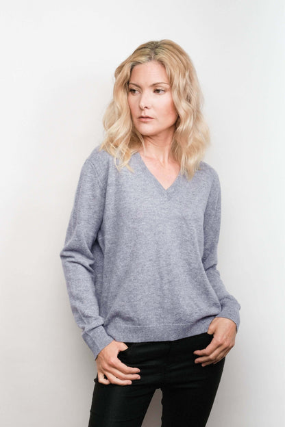 Model wearing grey cashmere V-neck sweater, studio view – Love Cashmere NZ