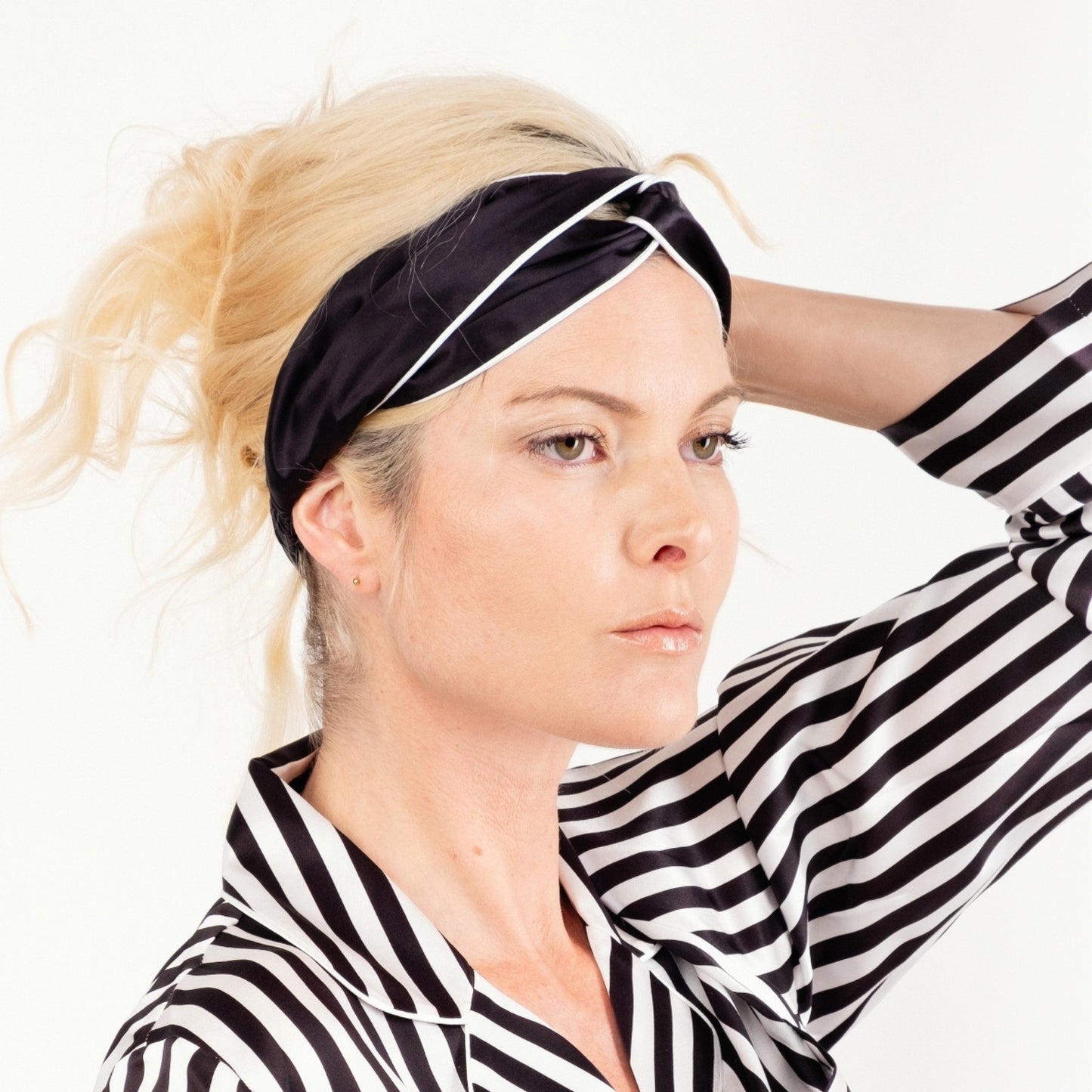 Model in striped pyjamas wearing black silk headband with white piping – LS Silk NZ