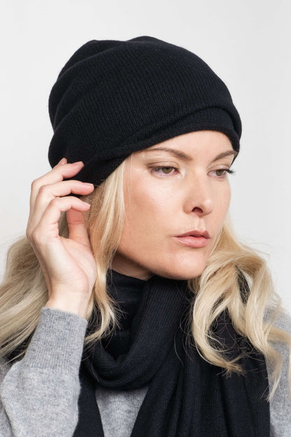 Model wearing black cashmere roll-edge beanie with black scarf – Love Cashmere NZ