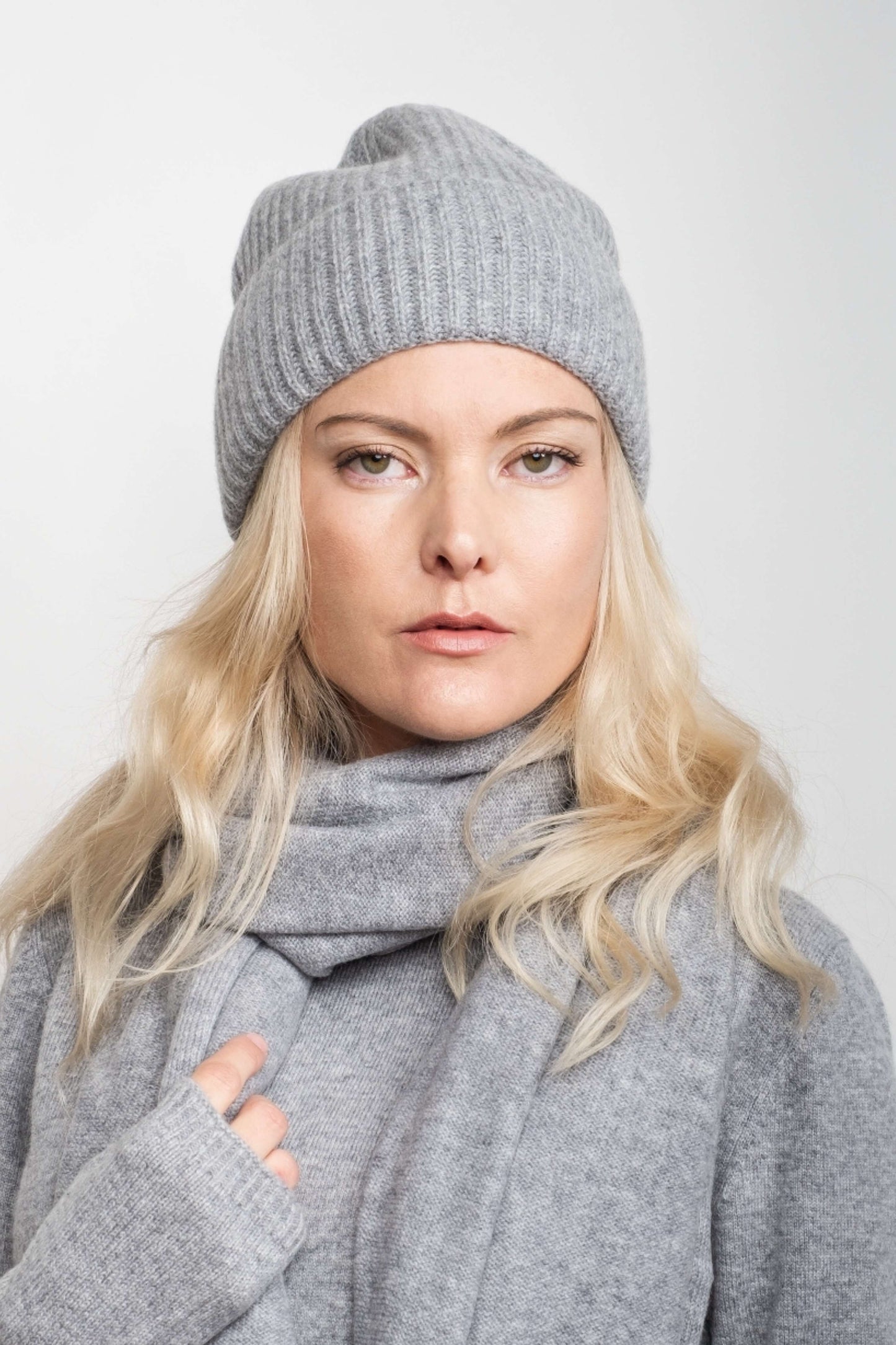 Woman wearing grey cashmere beanie and scarf, hands raised – Love Cashmere NZ