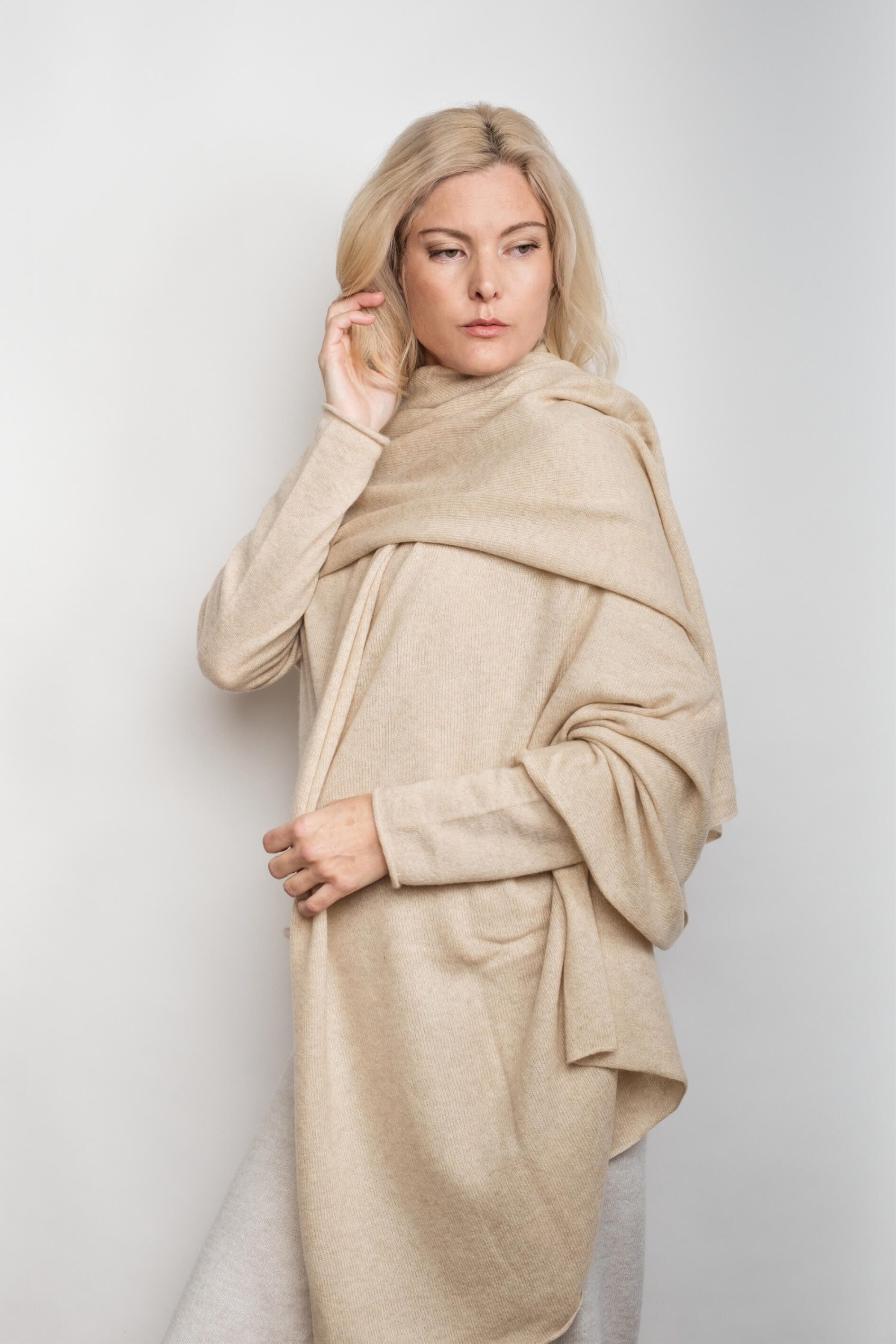 Model draped in oversized beige cashmere wrap poncho-style – Love Cashmere NZ