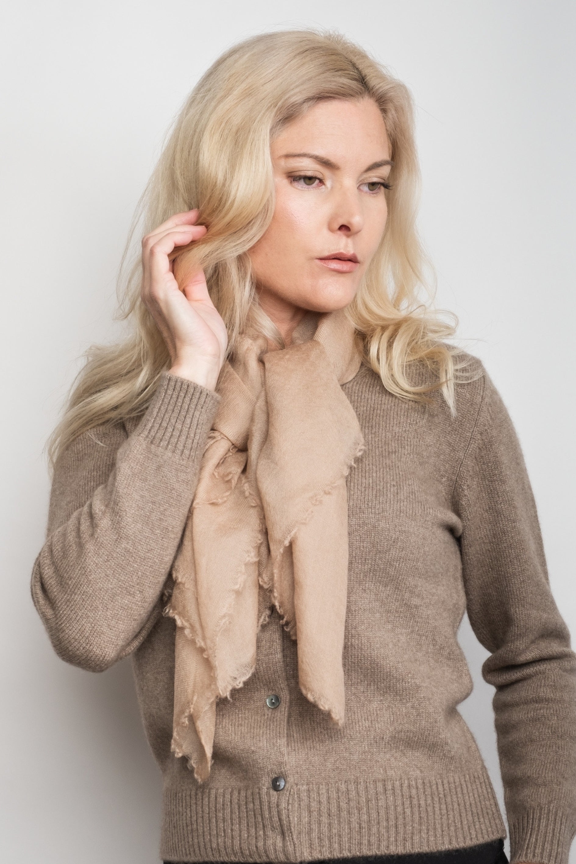 Model in taupe sweater wearing sand cashmere scarf tied at neck – Love Cashmere NZ