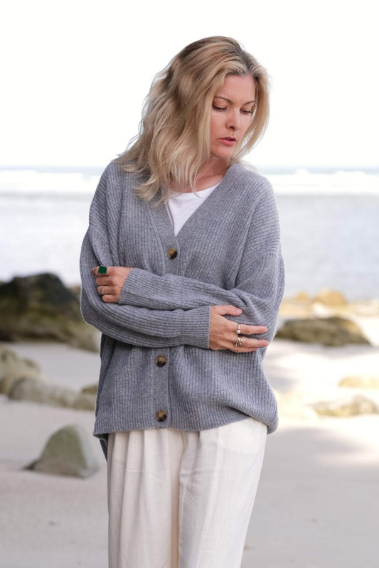 Woman at the beach in grey relaxed-fit cashmere cardigan – Love Cashmere NZ
