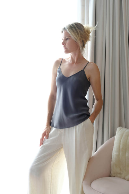 Woman in shadow grey mulberry silk camisole with white pants – LS Silk NZ