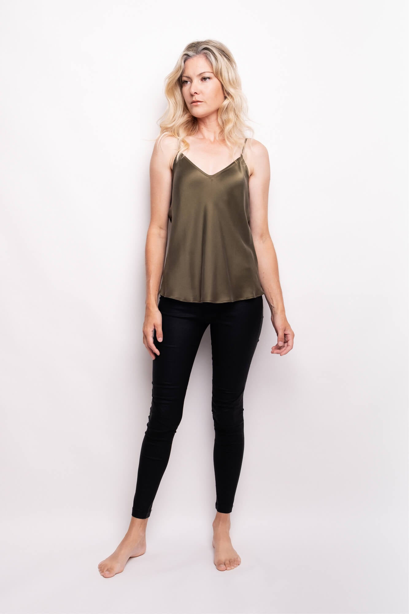Model wearing pine green silk camisole with black leggings – LS Silk NZ